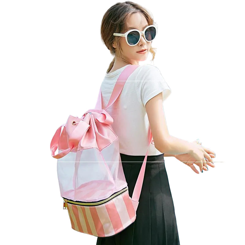 Pink mesh swim and beach bag worn over one shoulder